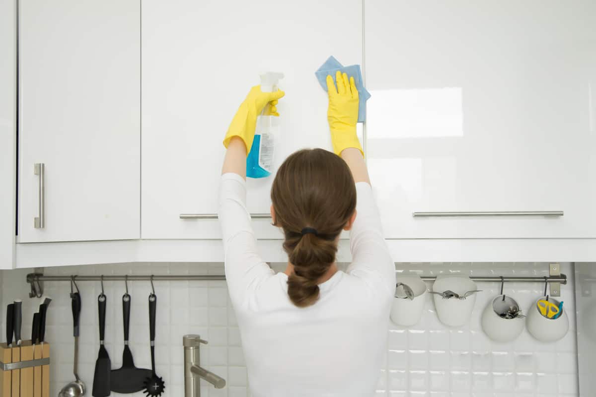 Woman cleaning a cabinet!