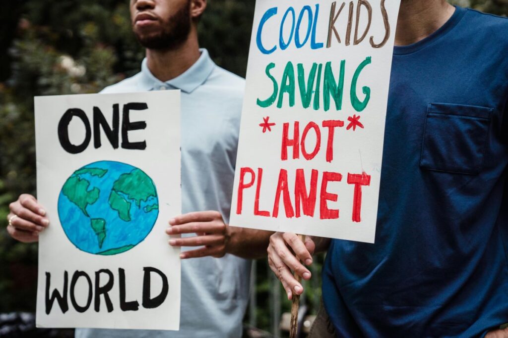 People in organization holding zero-waste living friendly signs