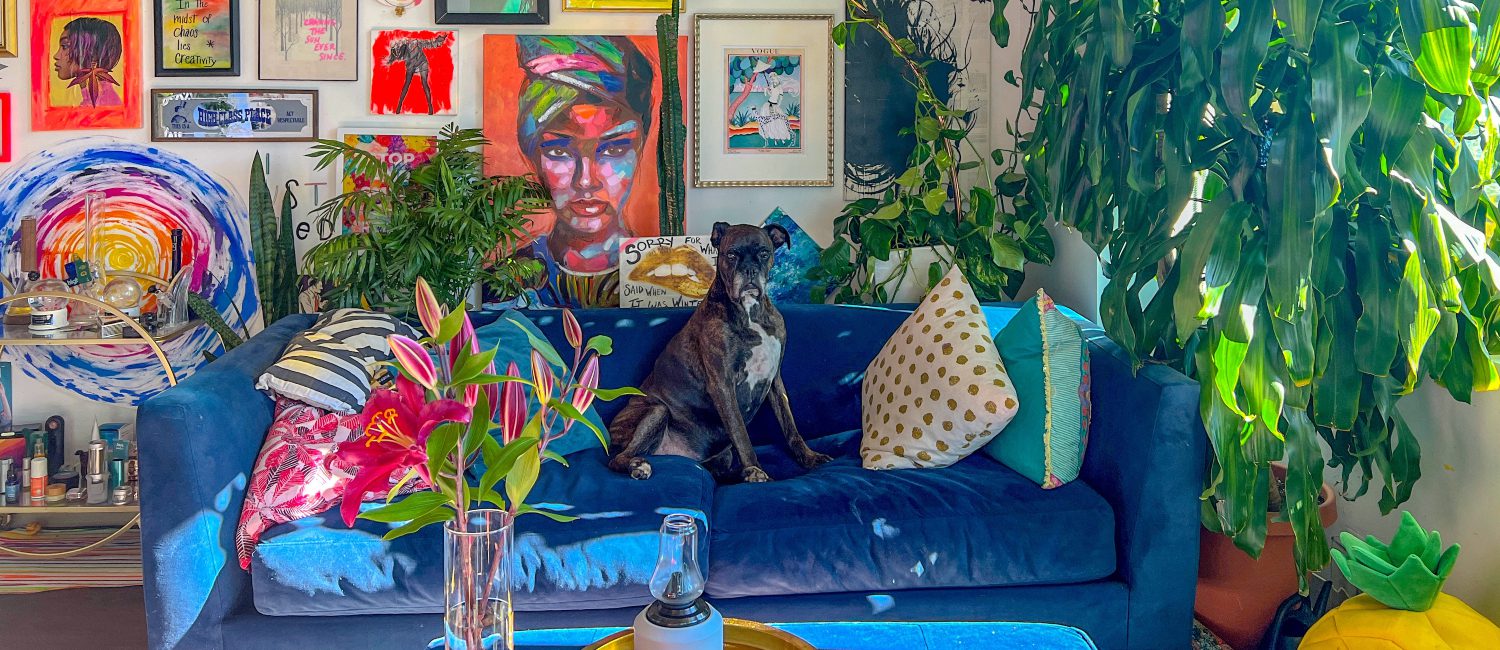 living room with maximalist decor, artwork and lots of indoor plants