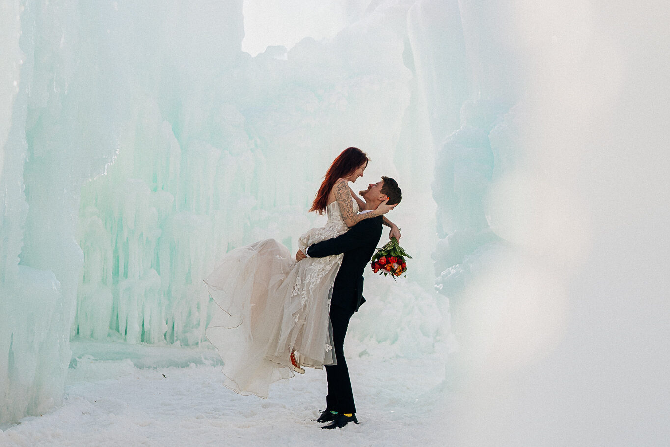 A couple posing for wedding photos in the Ice Castles held at the Minnesota State Fairgrounds