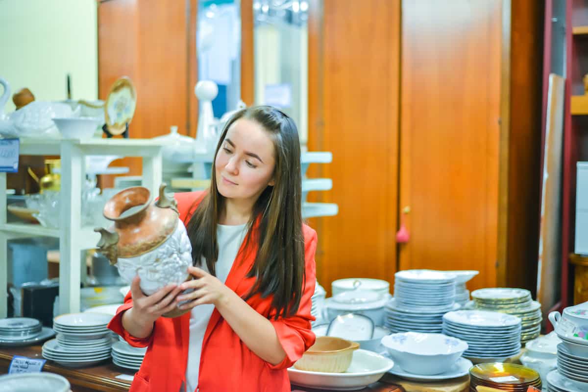 woman looking at vintage pot