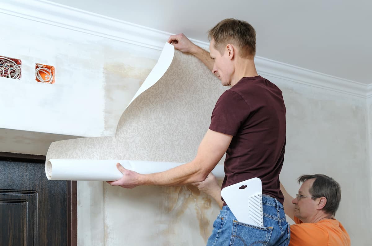 person removing wallpaper